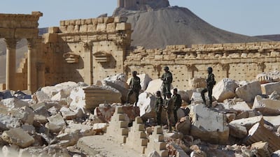 Syrian army soldiers stand in the ruins of the Temple of Bel, Palmyra, after ISIL’s onslaught of destruction. Omar Sanadiki / Reuters