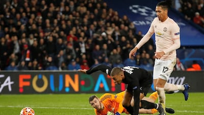 PSG's Kylian Mbappe in action with Manchester United's Chris Smalling and David de Gea. Reuters