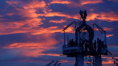 Participants watch the sunset from the Tower of Ascension as approximately 70,000 people gather for the 30th annual Burning Man arts and music festival in the Black Rock Desert of Nevada, US. Jim Urquhart / Reuters