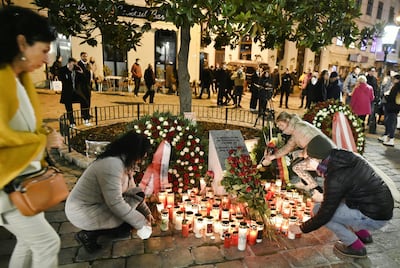 People leave flowers at a church in Vienna in memory of the four people killed in the attack. EPA