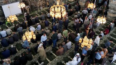 Worshippers are seen at the Al-Basha mosque, renovated and reopened after being destroyed during the war in Mosul, ahead of the holy month of Ramadan, in the old city of Mosul, Iraq. Reuters