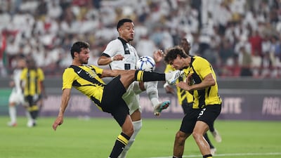 Al Jazira's Bruno, centre, battles with Al Ittihad's Faris Abdi, right and Houssem Aouar in an AFC Champions League Elite qualifier at Mohamed bin Zayed Stadium in Abu Dhabi. Chris Whiteoak / The National