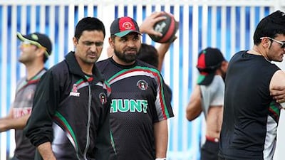 SHARJAH , UNITED ARAB EMIRATES – Mar 1: Kabir Khan , coach of Afghanistan Cricket team ( center ) with players during the practice session at Sharjah Cricket Stadium in Sharjah. ( Pawan Singh / The National ) For Sports. Story by Paul