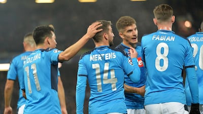 Dries Mertens (no.14) of Napoli celebrates with teammates after scoring the opening goal against Liverpool. EPA