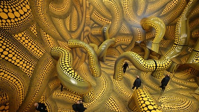 Visitors walk through an installation by Japanese artist Yayoi Kusama, 96, at the Museum Ludwig in Germany. AFP
