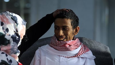 Released Saudi prisoner Moussa al-Awaji (R) waits to board an aircraft of the International Committee of the Red Cross (ICRC), after being freed by the Houthi rebels in January. EPA/Yahya Arhab