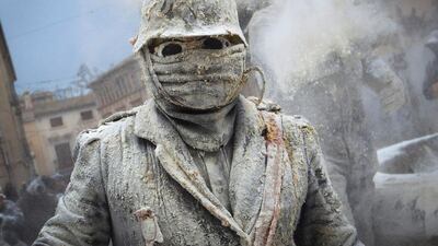 Revellers dressed in mock military garb take part in the “Enfarinats” battle in the southeastern Spanish town of Ibi. During this 200-year-old traditional festival, participants known as Els Enfarinats (those covered in flour) dress in military clothes and stage a mock coup d’etat as they battle using flour, eggs and firecrackers outside the city town hall. Jaime Reina / AFP