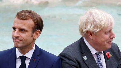 French President Emmanuel Macron and British Prime Minister Boris Johnson look on in front of the Trevi Fountain during the G20 summit in Rome. Reuters
