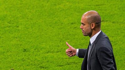 Bayern Munich manager Pep Guardiola flashes a thumbs up during his side's win over Manchester City in the Uefa Champions League on Wednesday night. Andreas Gebert / EPA / September 17, 2014