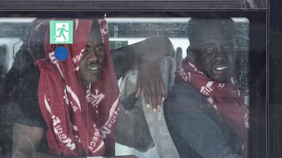 Rescued passengers sit in a bus. AFP