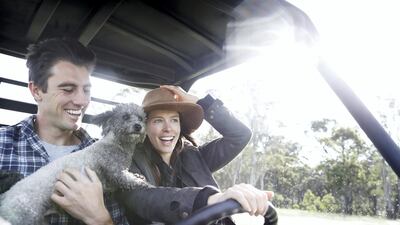 Pat Cummins, fiance Becky Boston, and their dog Norman ride on their farm buggy while in isolation at their property south of Sydne in Southern Highlands, Australia. Getty