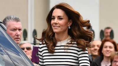 The Duchess of Cambridge wears a Breton stripe top, with LK Bennett Parker trousers, Emmy London block heels and a red Emmy London clutch as she arrives to launch the King's Cup Regatta at the Cutty Sark in London on May 7. Reuters