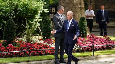 Mr Biden makes his way to 10 Downing Street. AP