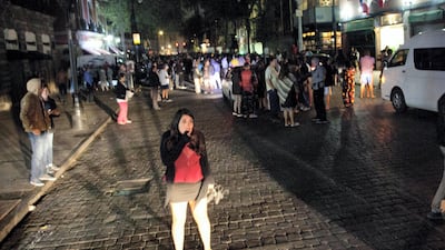 People gather on a street in downtown Mexico City after an 8.1-magnitude earthquake struck southern Mexico . Pedro Pardo / AFP Photo