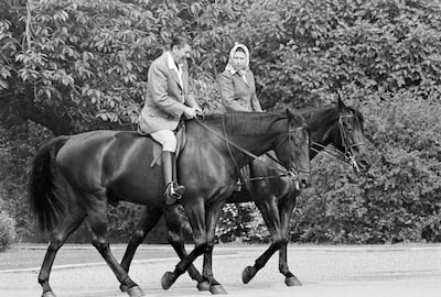 Former US president Ronald Reagan, on Centennial, and Queen Elizabeth II, on Burmese, ride on the grounds of Windsor Castle, England, in 1982. AP