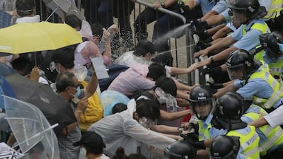 Riot police use pepper spray against protesters after thousands of people block a main road to the financial central district outside the government headquarters in Hong Kong, sending traffic to a standstill on September 28, 2014. Vincent Yu/AP Photo
