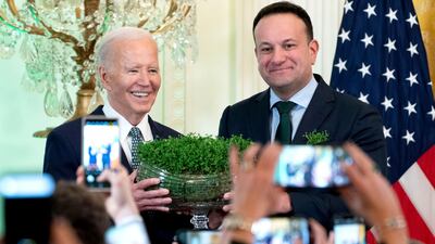 Mr Varadkar presents US President Joe Biden with a bowl of shamrocks at the White House in Washington in March 2024. Bloomberg