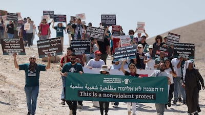 Palestinians and Israeli left-wing activists protest new settlements in the West Bank. AFP.