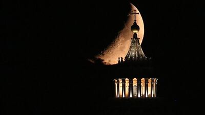 The moon is seen behind the Saint Peter’s Basilica during ‘The Night of the Moon’ in Rome, Italy. Alessandro Di Meo / EPA