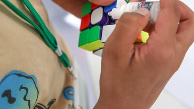 A competitor lubricates his cube before he competes