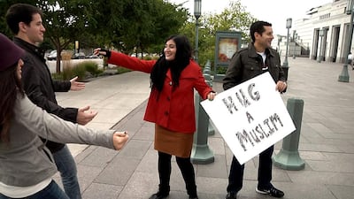 Negin Farsad with the Hug A Muslim sign in the documentary The Muslims Are Coming! Courtesy of Vaguely Qualified Productions