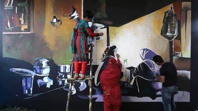 A group of art students paint the walls of a flyover on a street in Srinagar. Farooq Khan / EPA