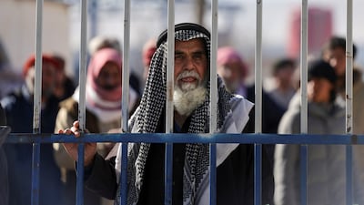 Detainees behind a gate after the Syrian government took control of Al Hol. Reuters