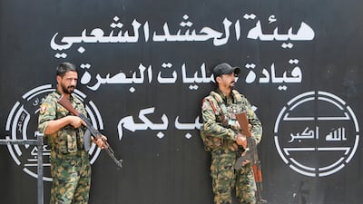 Members of Iraq's Popular Mobilisation Forces stand guard outside the Basra Operations Command headquarters. Reuters