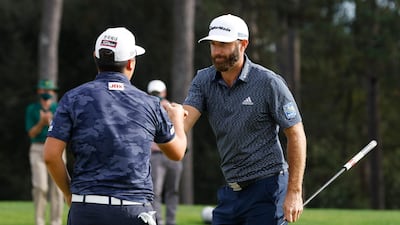 Dustin Johnson of the US with South Korea's Sungjae Im on the 18th green after winning The Masters. Reuters