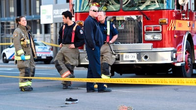 Shoes lay on the street as first responders secure the area in Toronto. The driver of the van was taken into custody, Canadian police said. Nathan Denette/The Canadian Press via AP