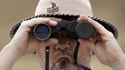 Paul Heine watches play on the 10th hole during the first round. Charlie Riedel / AP Photo / June 18, 2015