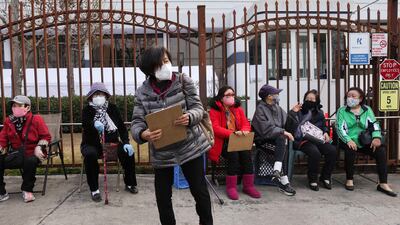People who were waiting in line sit after being told there were no more Covid-19 vaccine doses available for those without appointments at the Kedren Community Health Centre in South Los Angeles in Los Angeles, California. AFP