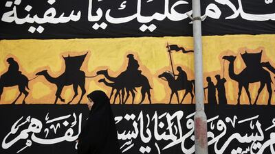 A Bahraini girl passes by decorations put up in the western village of Malkiya, Bahrain. Hasan Jamali / AP Photo