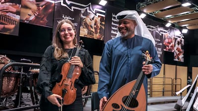 Ukrainian violinist Yuliya Ostapchuk and Emirati oud player Abdulaziz Al Madani of UAE National Orchestra ahead of its debut performance. Victor Besa / The National