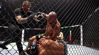 Referee Mark Goddard calls off the fight as Alexander Volkanovski reins down punches on Movsar Evloev.