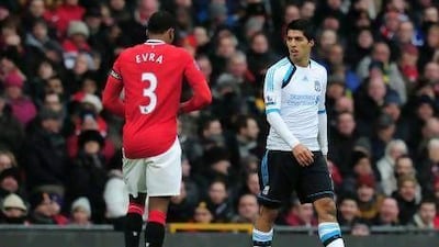 Liverpool's Luis Suarez, right, says has apologised for not shaking the hand of Patrice Evra of Manchester United.