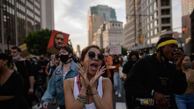 Black Lives Matter protesters hold placards and shout slogans in Brooklyn, New York. AFP