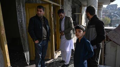 People inspect a damaged house after several rockets land at Khair Khana, north west of Kabul. A series of loud explosions shook central Kabul on November 21, including several rockets that landed near the heavily fortified Green Zone where many embassies and international firms are based, officials said. AFP