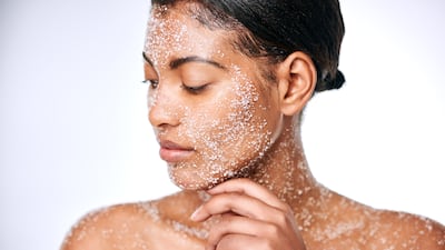 Using a face and body scrub increases blood flow and helps skincare products get absorbed better. Getty Images