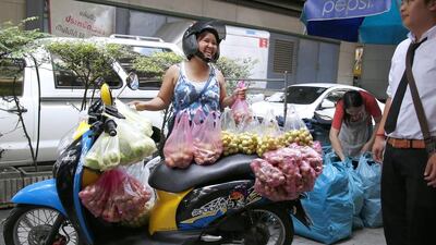 A small enterprise Thai businesswoman uses her motorbike as the platform to sell local grown fruits, from the empty spot she has found on a busy pavement as workers pass by during the lunch break in Bangkok. Asia Pacific Economic Cooperation (APEC) finance ministers met in Beijing, China, on October 22, to tackle a slowdown in economic growth in the region. Financial sources predict the Thai economy will grow only 1.7 per cent in 2014, less than the earlier forecast of 2 per cent, due to the lagging export performance and slow pace of domestic consumption. Barbara Walton / EPA