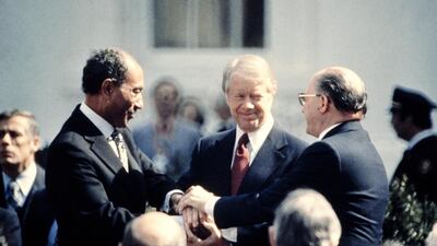 US president Jimmy Carter congratulates Egyptian president Anwar Sadat, left, and Menachem Begin, Israeli prime minister, in a three-way handshake at the White House in 1979 after the signing of a peace treaty between Israel and Egypt. AFP