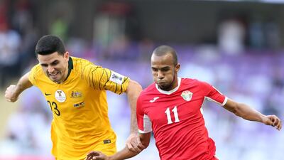 Yaseen Bakheet, right, of Jordan tussles with Tom Rogic of Australia. EPA