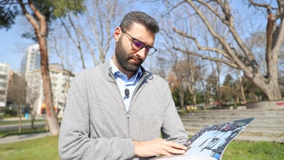 ISTANBUL, TURKIYE - FEBRUARY 29: Motaz Azaiza, Palestinian photojournalist who worked and first handedly saw the Israeli attacks in the Gaza for 107 days, examines the Evidence book released by Anadolu which contains the weapons and tactics used by Israel on Gaza, in Istanbul, Turkiye on February 29, 2024. (Photo by Mustafa Hassouna/Anadolu via Getty Images)