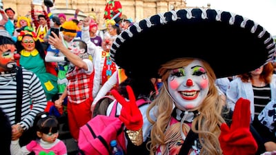 A clown flashes the V sign. AFP