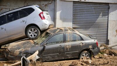 Cars stacked on top each other, after being washed away by floodwaters in Derna. AP