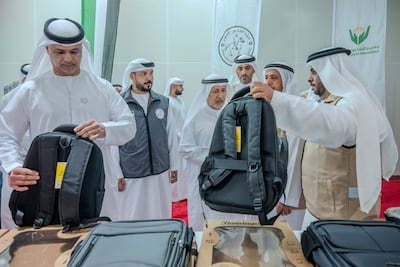 Officials look at school and stationery supplies included in a shipment bound for Gaza. Sharjah International Airport, 19th August 2026. Photo: Ahmed Ramzan / The National