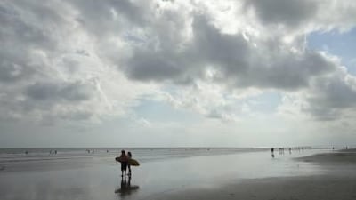 The black beaches of Seminyak, Bali, make for difficult surfing, but offer a rest for the weary acupressure patient after a day's session.