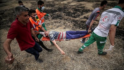 Palestinians medics carry a wounded protester during clashes after Friday protests near the border with Israel in eastern Gaza City. Mohammed Saber / EPA