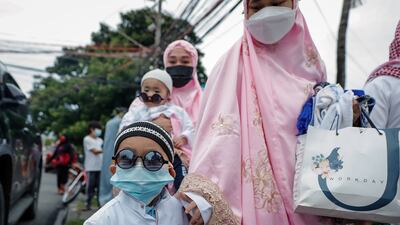 A child arrives with his family to mark Eid Al Adha at the Blue Mosque in Taguig city, south of Manila, in the Philippines.
