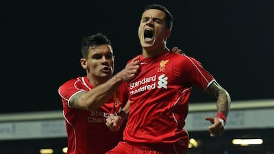 Liverpool's Philippe Coutinho celebrates with Dejan Lovren after scoring the eventual winner in a 1-0 victory over Blackburn on Wednesday night to reach the FA Cup semi-finals. Paul Ellis / AFP / April 8, 2015